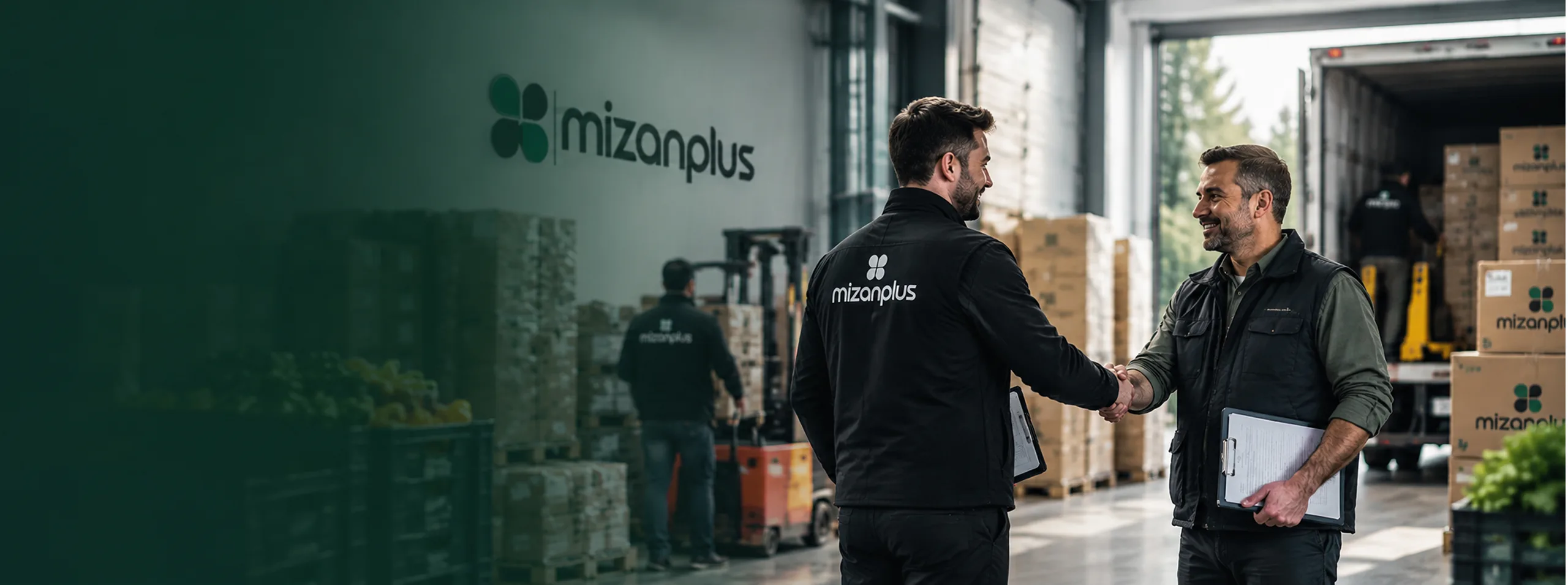 Business partners shaking hands in a Mizanplus warehouse